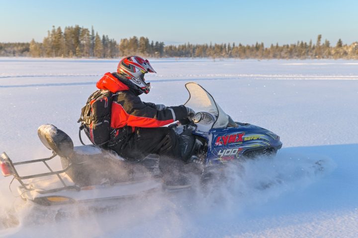 a man riding a snow board on a body of water